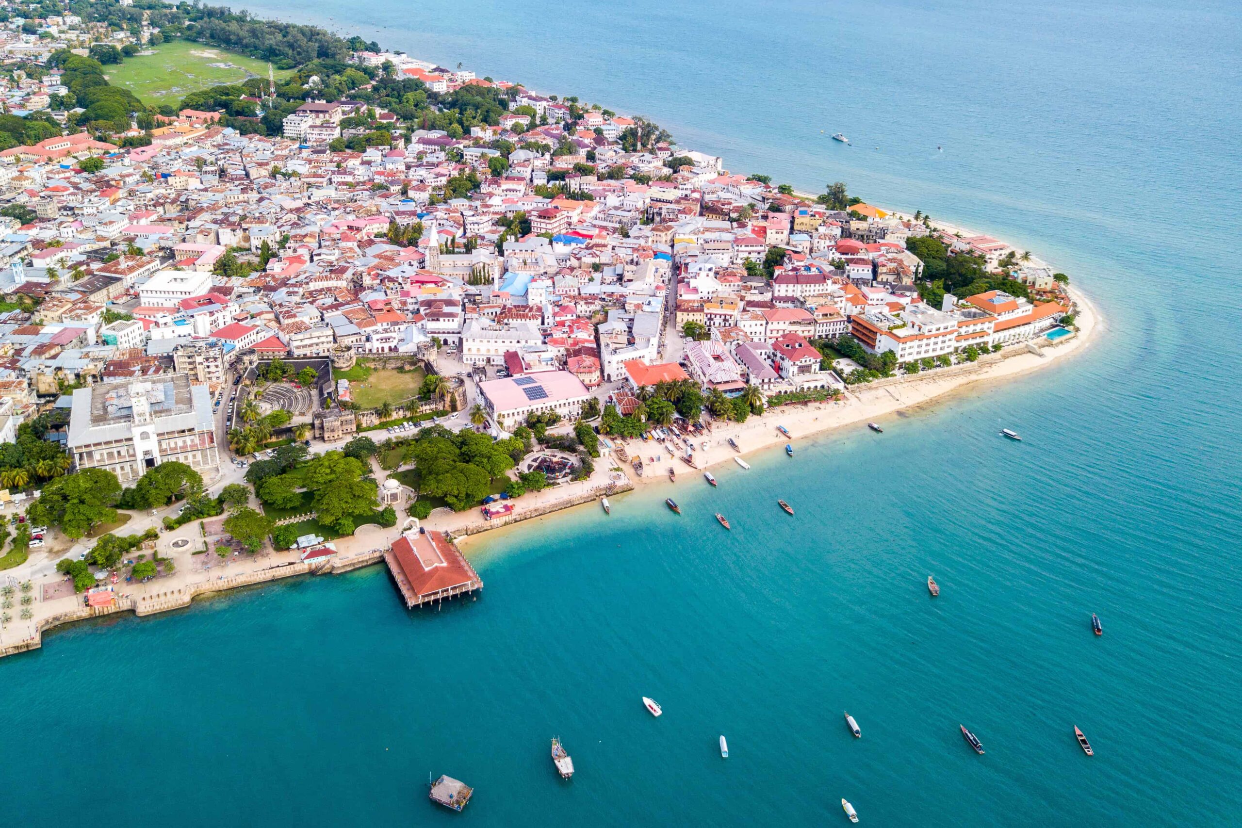 Stone Town, old colonial center of Zanzibar City. House of Wonders. The Old Fort (Arab Fort built by Sultan of Oman). Azure sea and stunning yellow beaches. Unguja island, Tanzania. Aerial done photo.